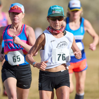 Woman running in a race with other runners in the background